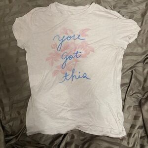 Pink girl shirt leaves blue letters “You got this”